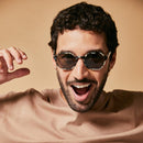 Male model wearing black and white polarised sunglasses from Ozeano 