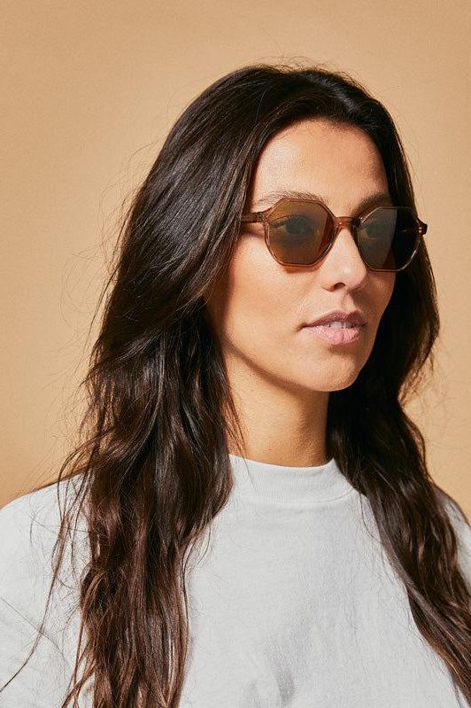 Female model wearing brown polarised sunglasses from Ozeano Vision