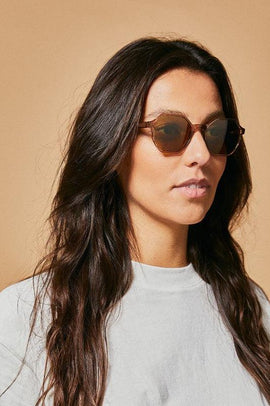 Female model wearing brown polarised sunglasses from Ozeano Vision