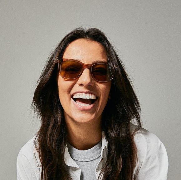 Female model wearing brown polarised sunglasses from Ozeano Vision