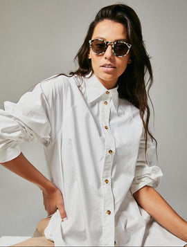 Female model wearing black and white polarised sunglasses