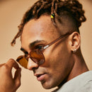 Male model wearing brown polarised sunglasses