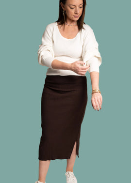 Adrienne wearing an all occasion white long sleeve top and brown skirt